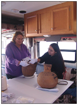 Terri Schindel and Melody Pickup (an intern at the Southern Ute Cultural Center and Museum in Ignacio, CO) conducting a preliminary condition examination of a basket.